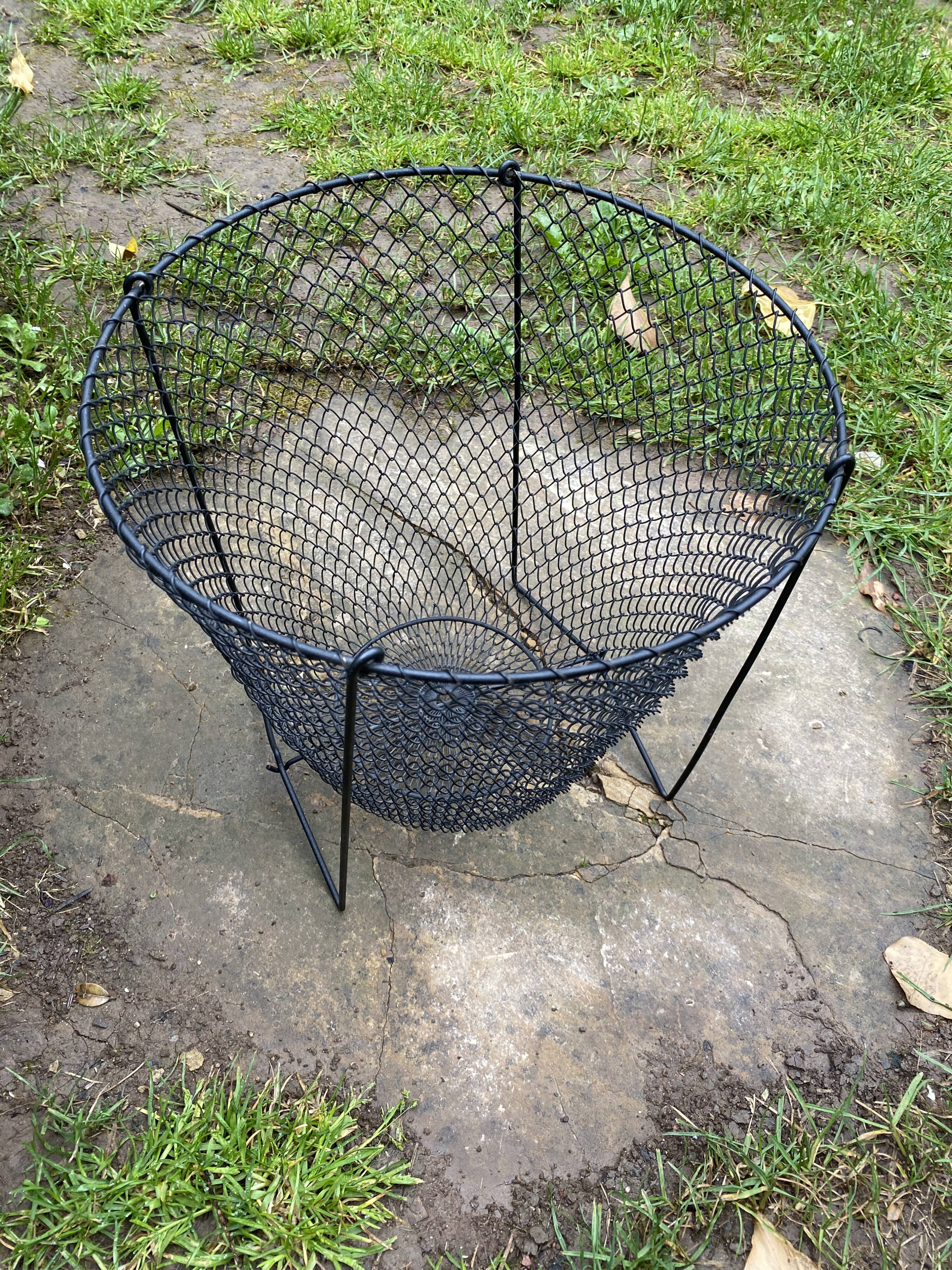 Foldable black woven metal wastepaper basket from around 1950.