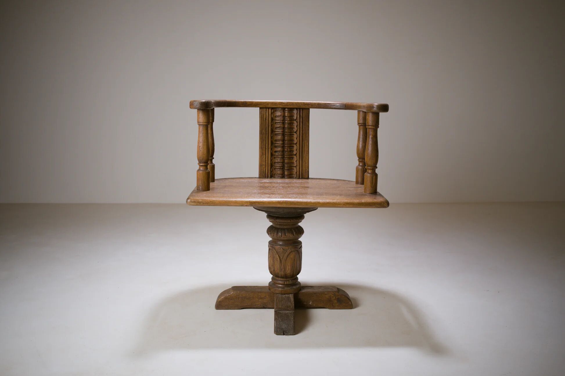 Swivel armchair in carved oak with ball bearings, early 20th century.