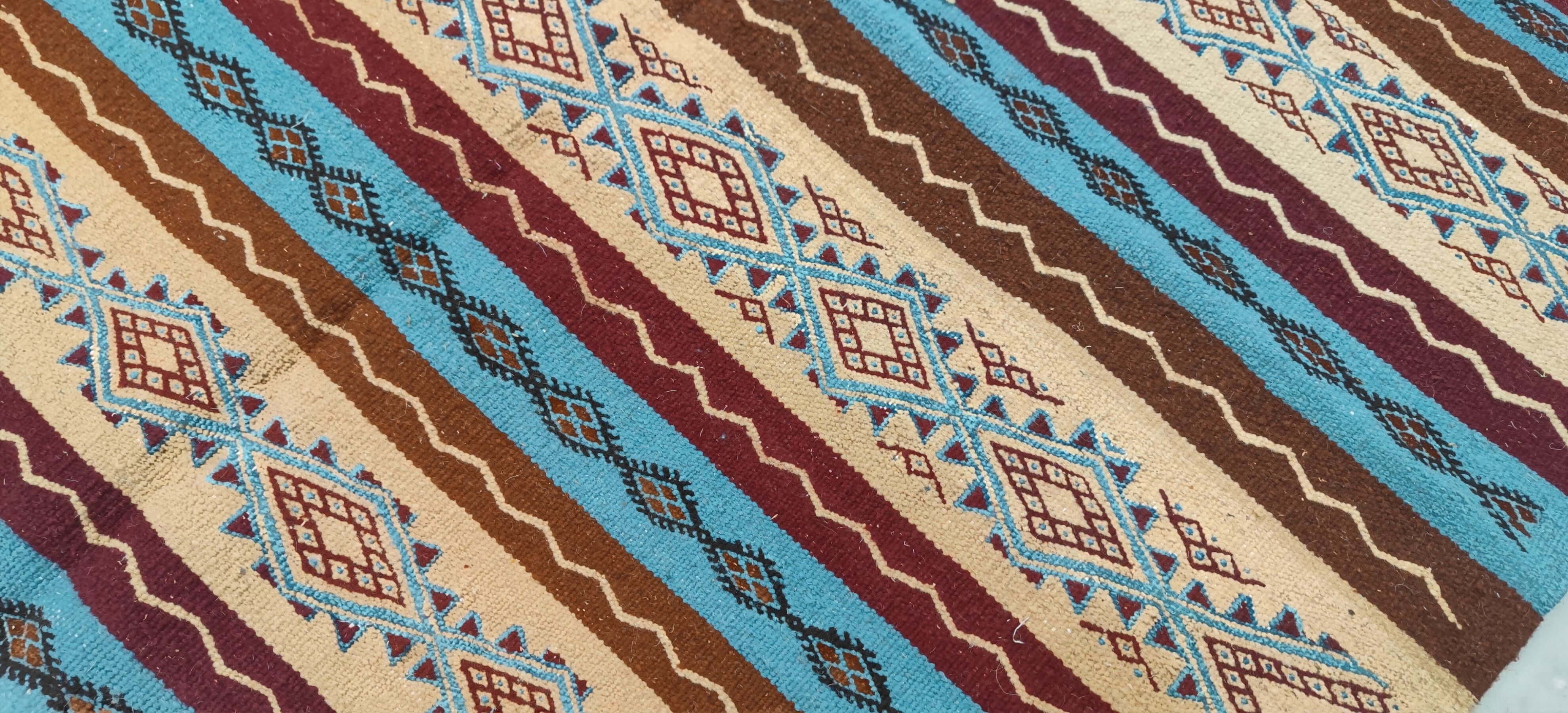 Multicolored hand-woven Berber rugs in natural wool