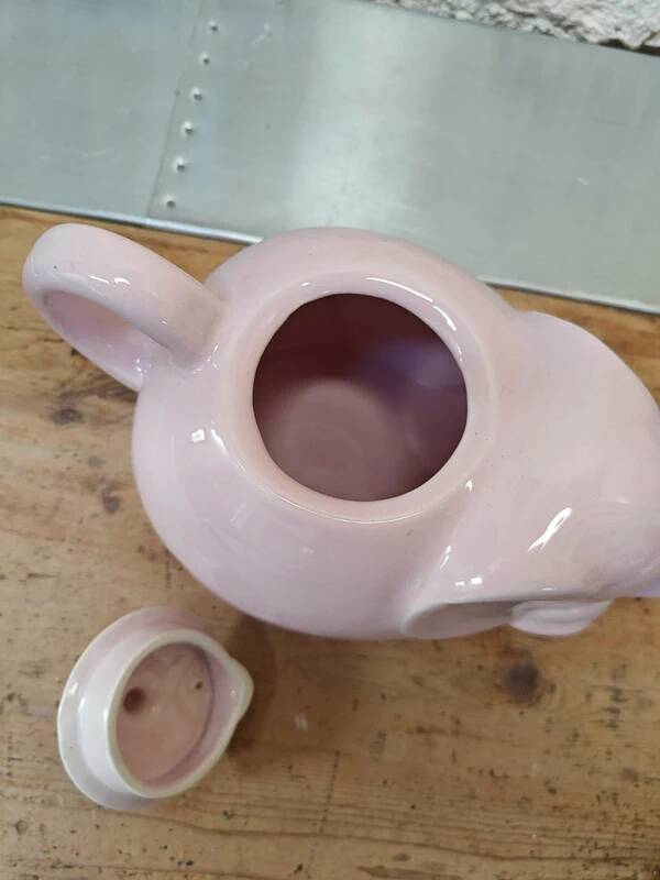 Antique pink elephant teapot in earthenware.