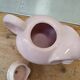 Antique pink elephant teapot in earthenware.