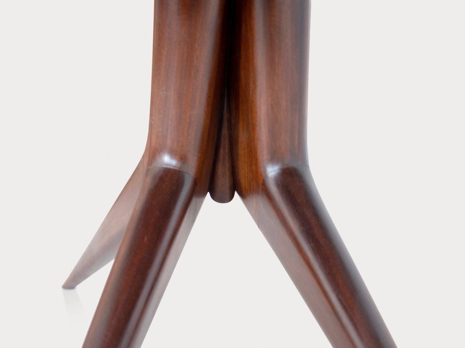 Dining table with a wooden frame and tinted glass top.