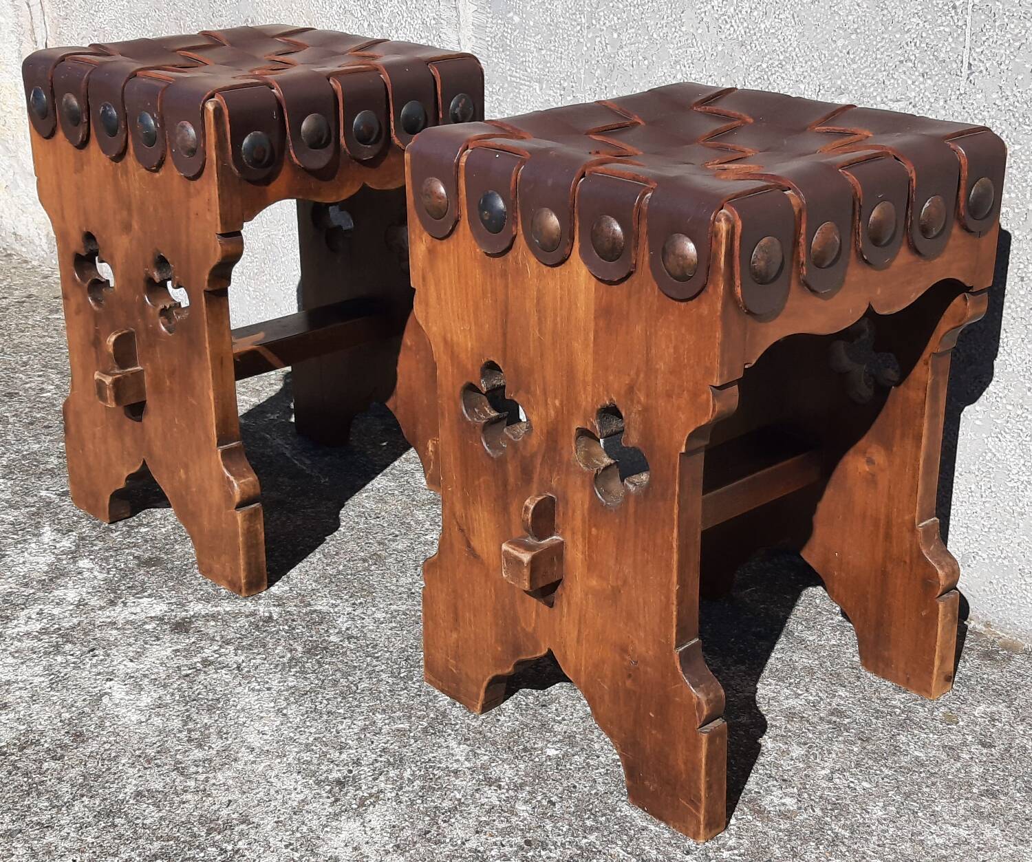 Pair of brutalist stools, leather seat.