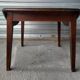 Antique round farmhouse table with drop-leaf doors in solid pegged wood