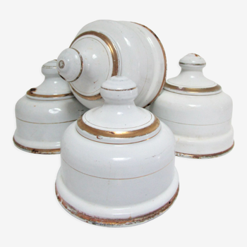 Four white enamelled metal cheese bells early twentieth century