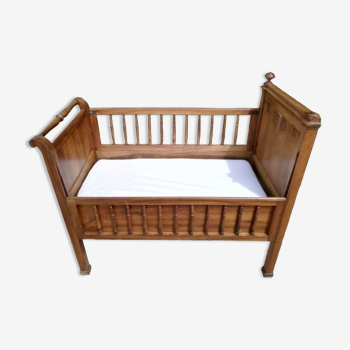 Old children's bed with retractable walnut bars