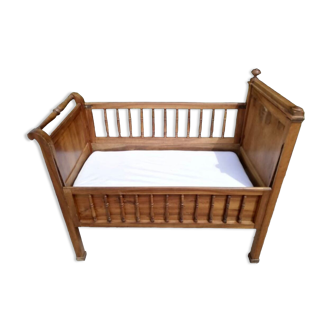 Old children's bed with retractable walnut bars