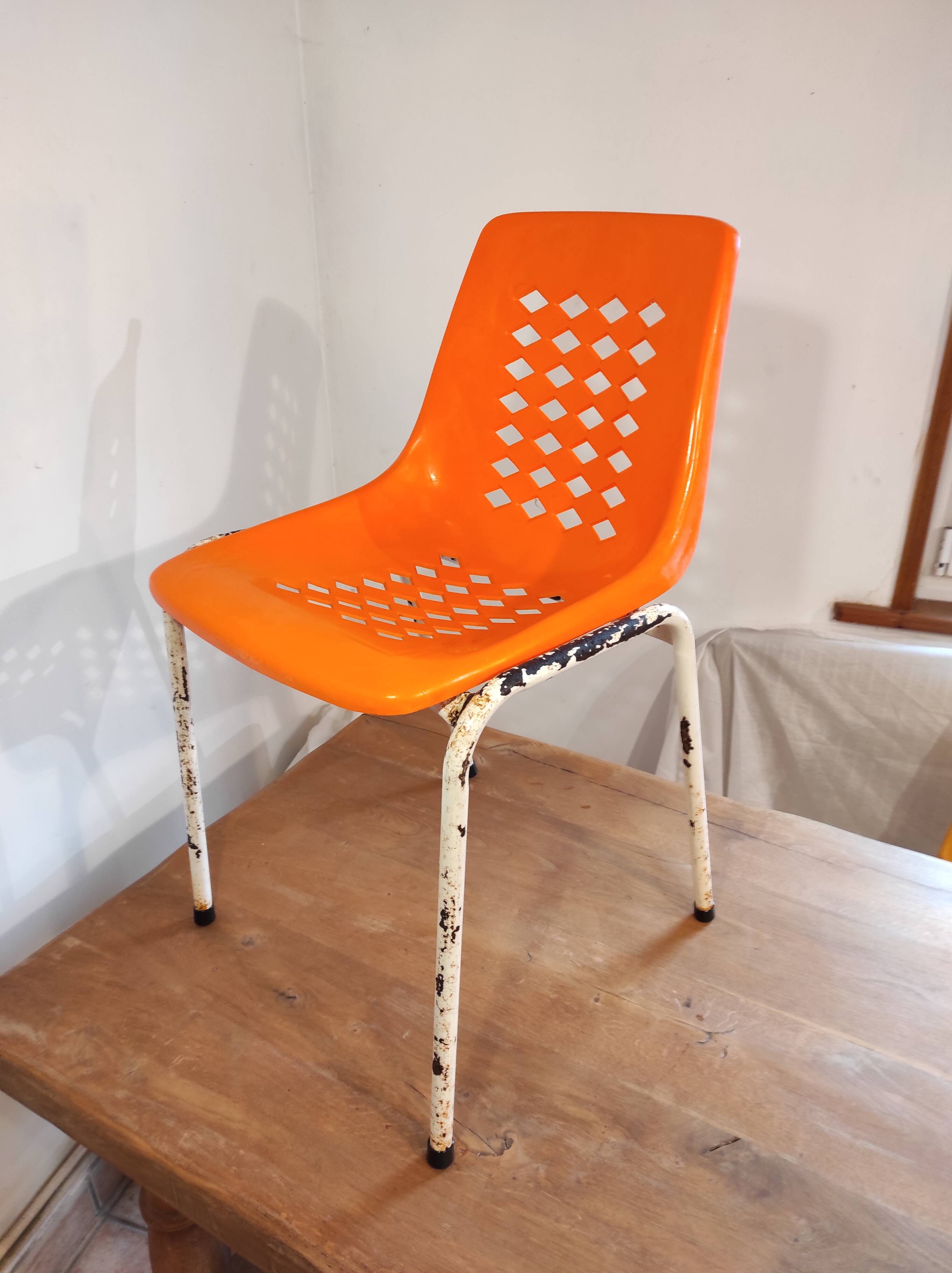 Chair with openwork plastic shell 1970