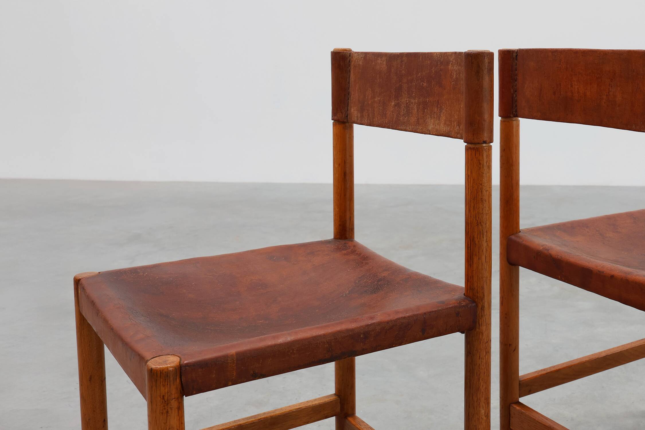Pair of wood and leather Spanish chairs by Jordi Vilanova, ca. 1960