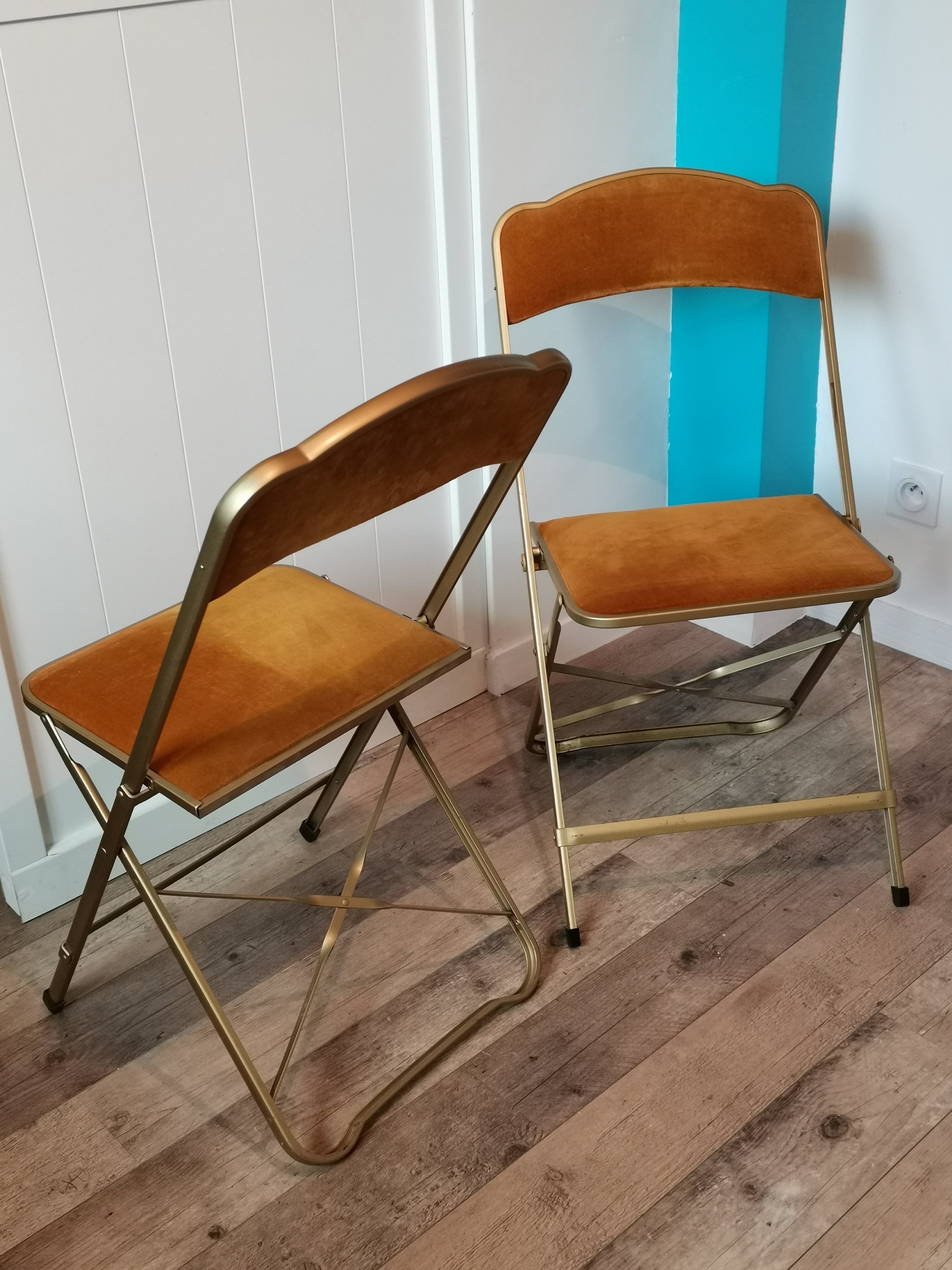 Two gold velvet folding chairs