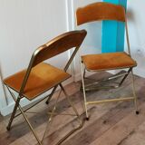 Two gold velvet folding chairs