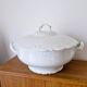 White porcelain soup tureen from Limoges with a vegetal scroll design.