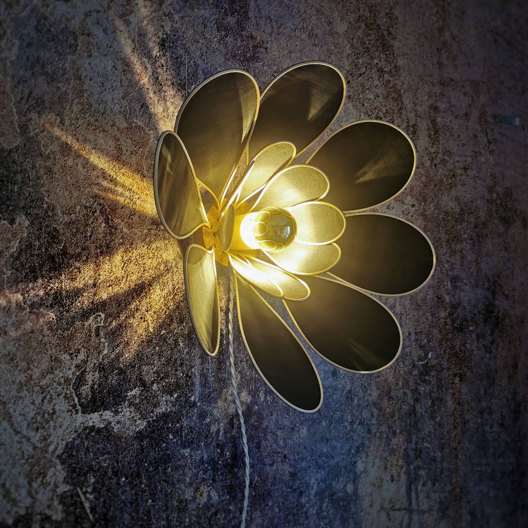 Flower wall light made of rattan and fir green linen petals