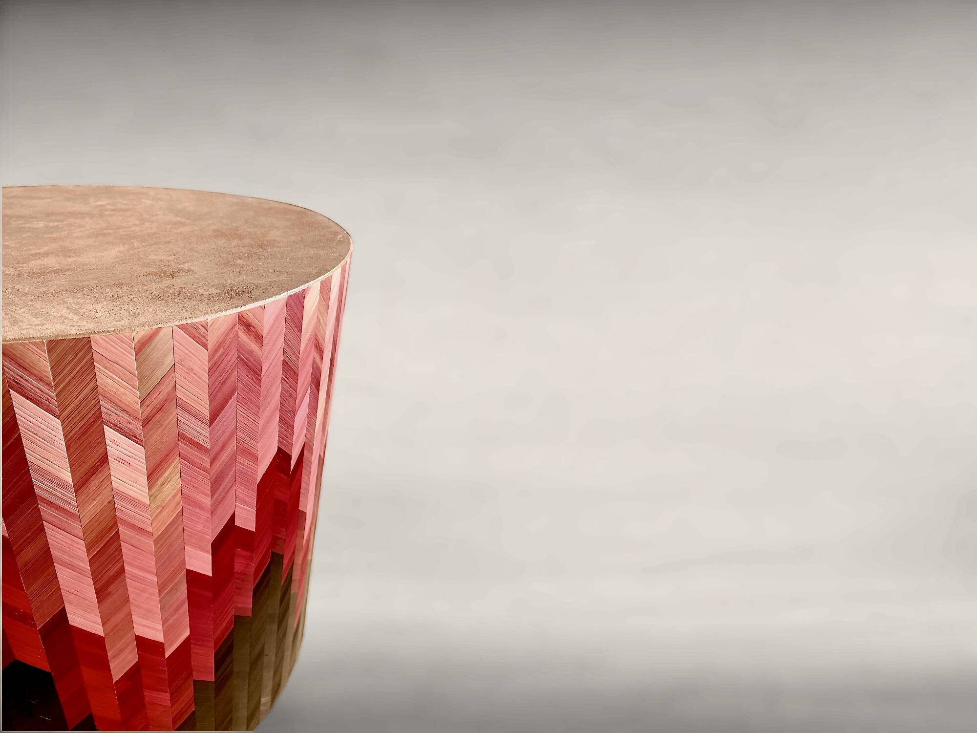 Side table with straw/inlaid concrete.