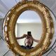 Miroir ovale médaillon en stuc doré années 70