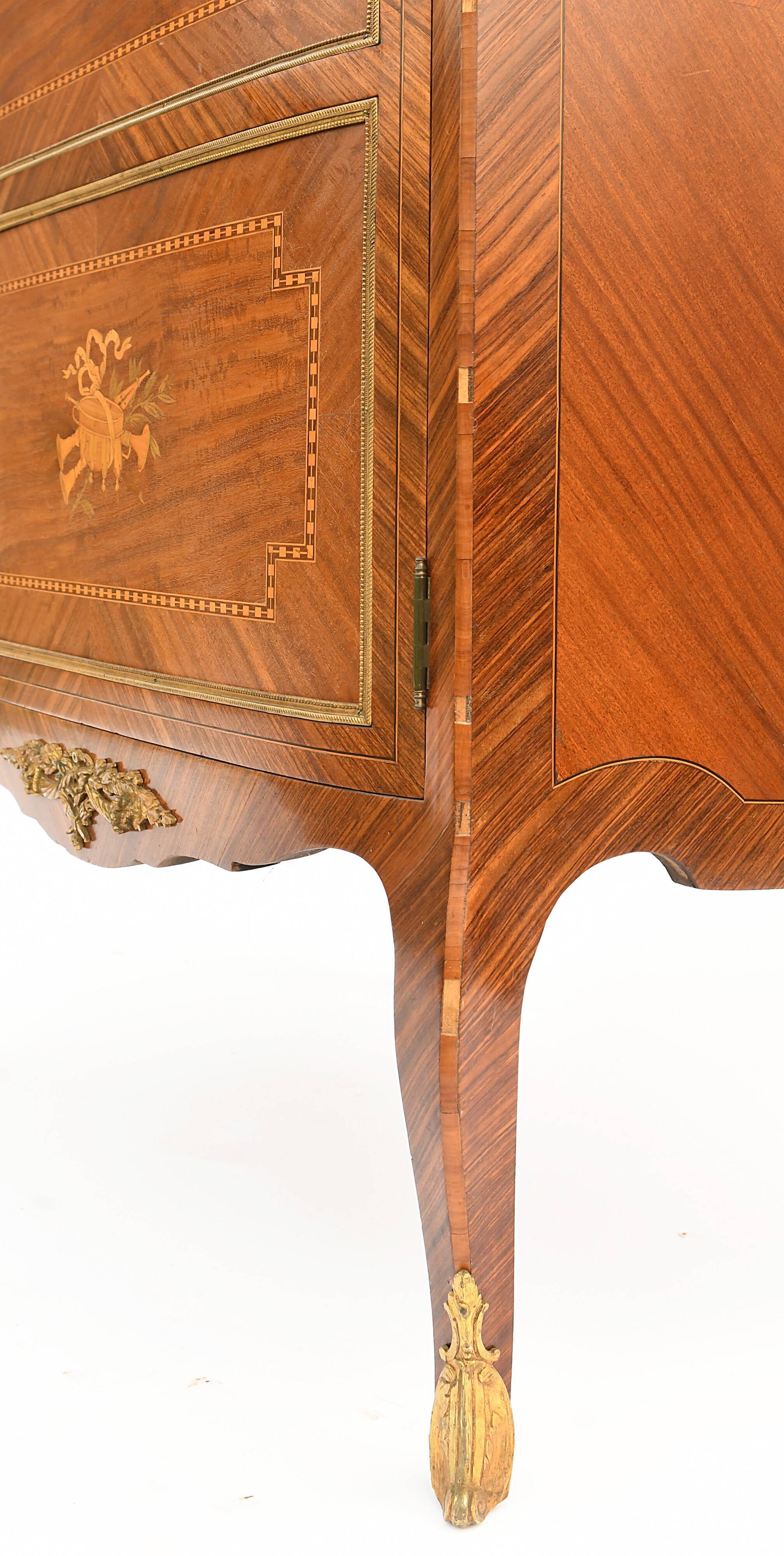 In-between furniture in marquetry decorated with a trophy decoration of musical instruments