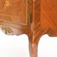 In-between furniture in marquetry decorated with a trophy decoration of musical instruments