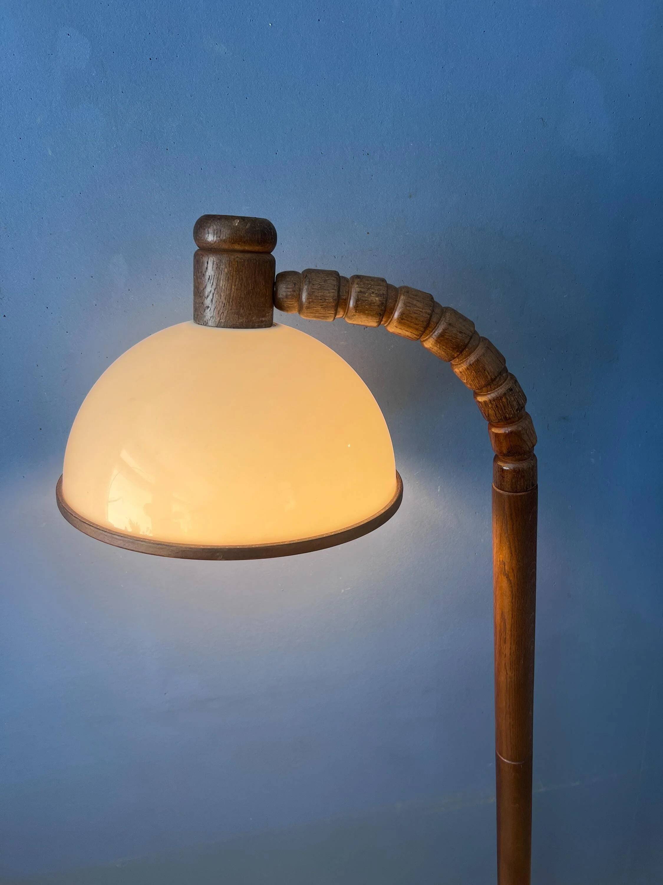 Mid-century floor lamp in brown wood by Steinhauer with an acrylic glass shade.