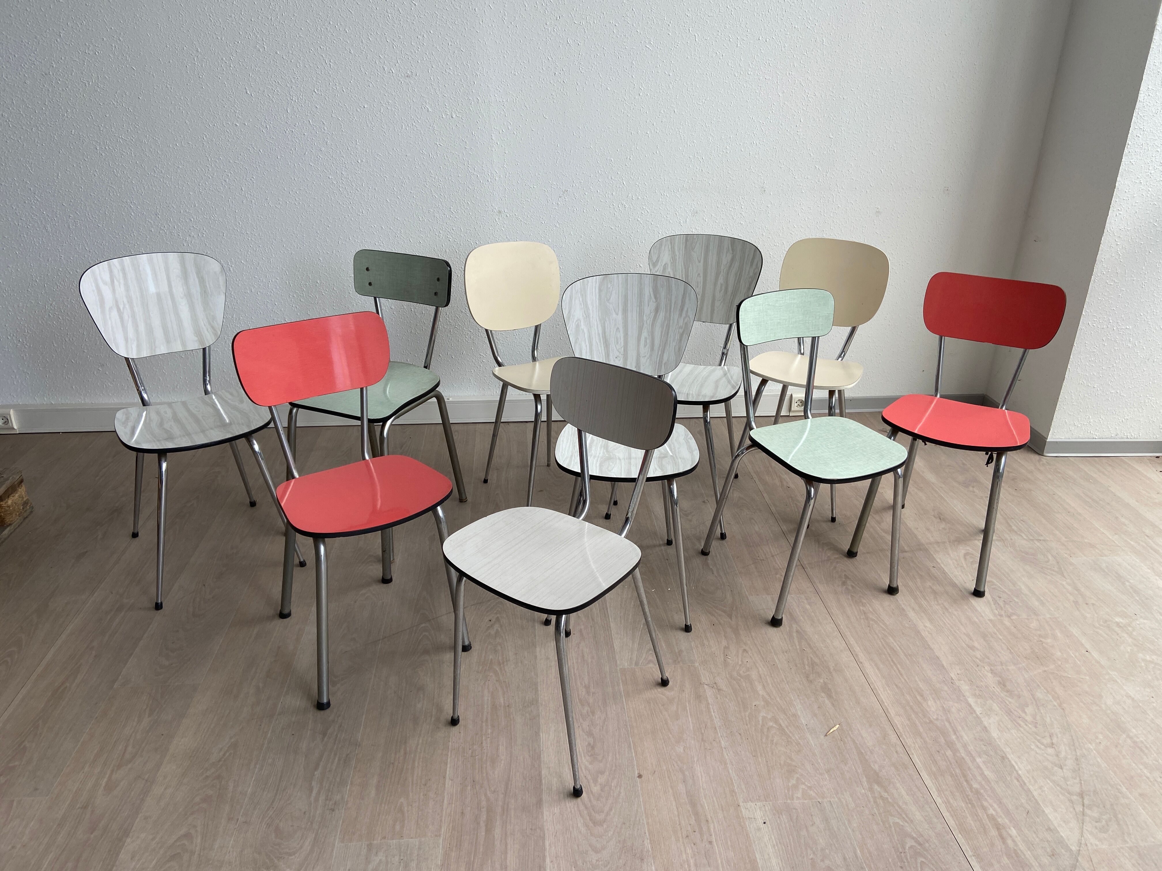 10 mismatched multicolored Formica chairs 60s