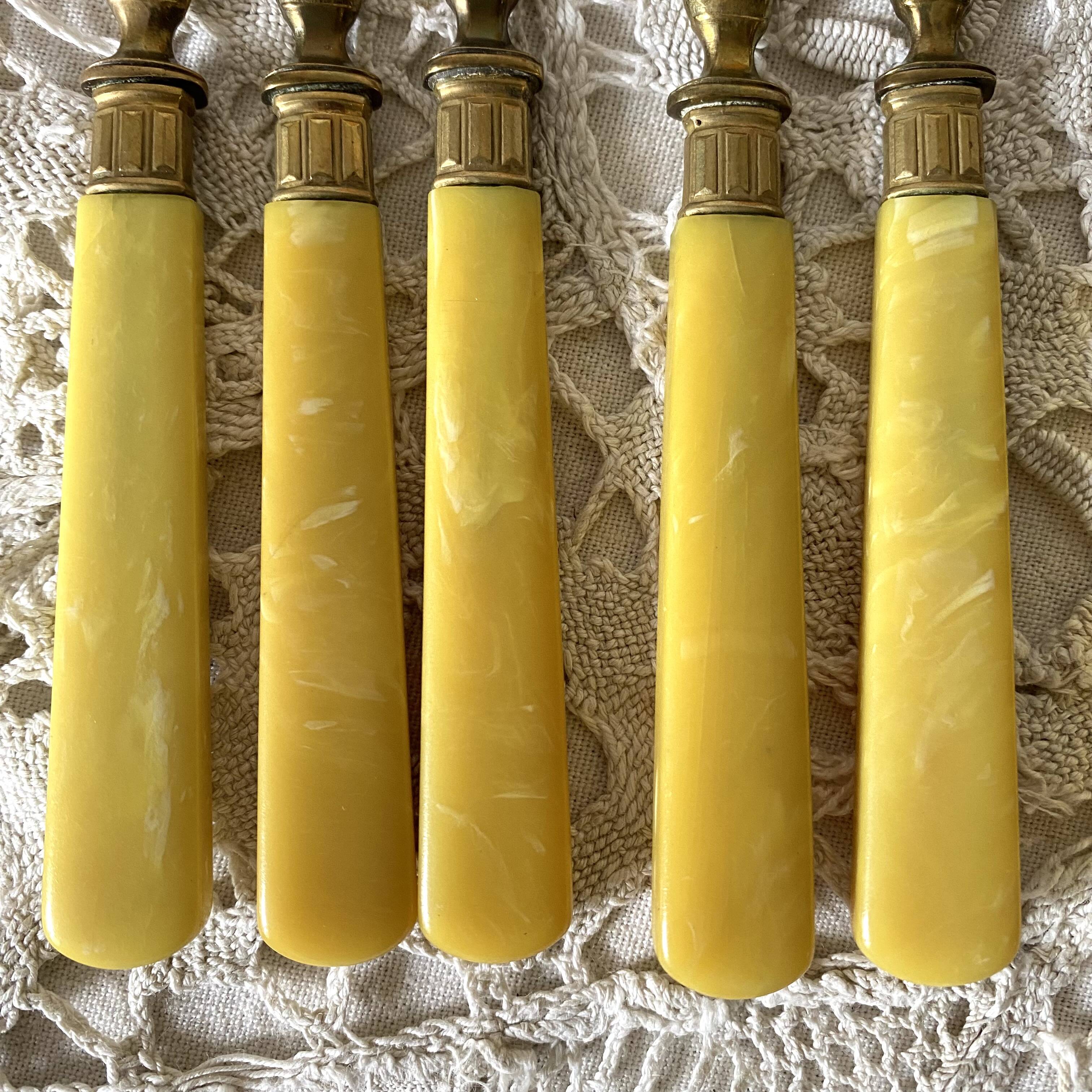 Antique dessert forks in brass and bakelite
