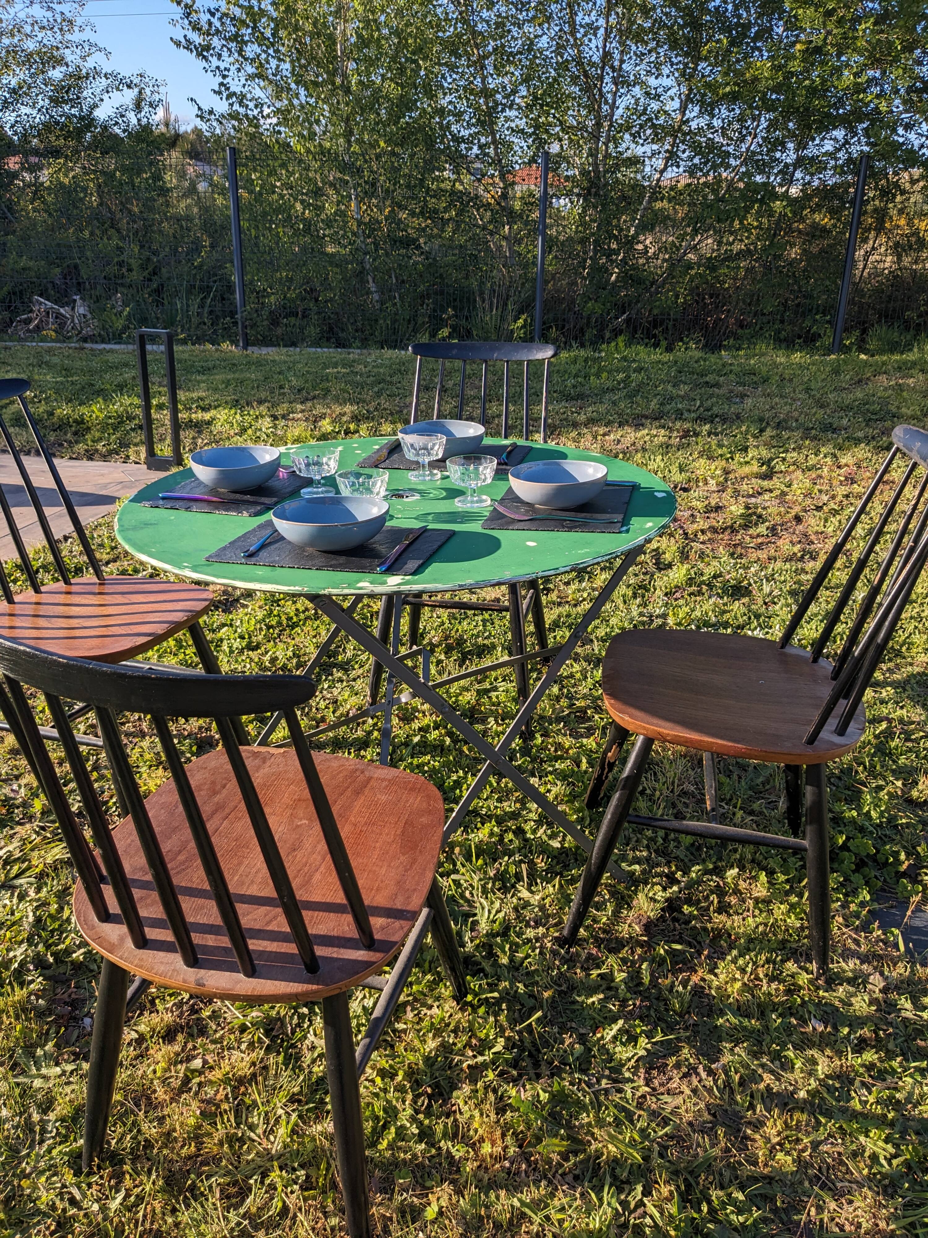 Antique round folding garden table with a green patina.