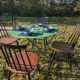 Antique round folding garden table with a green patina.