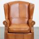 Fauteuil à oreilles en cuir de vache