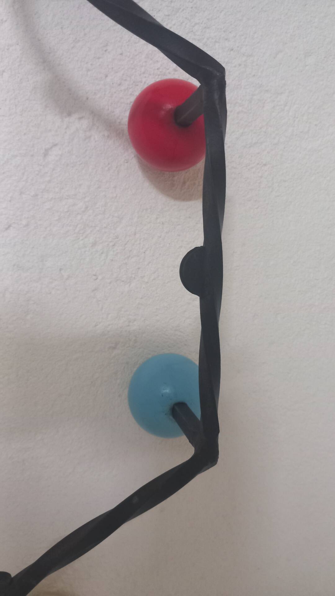 Vintage wall coat rack "Atomic" in wrought iron with multicoloured balls.
