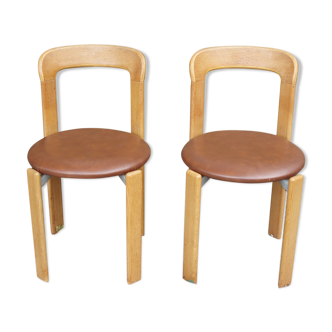 Pair of chairs by Swiss designer Bruno Rey in wood and brown skai