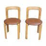 Pair of chairs by Swiss designer Bruno Rey in wood and brown skai