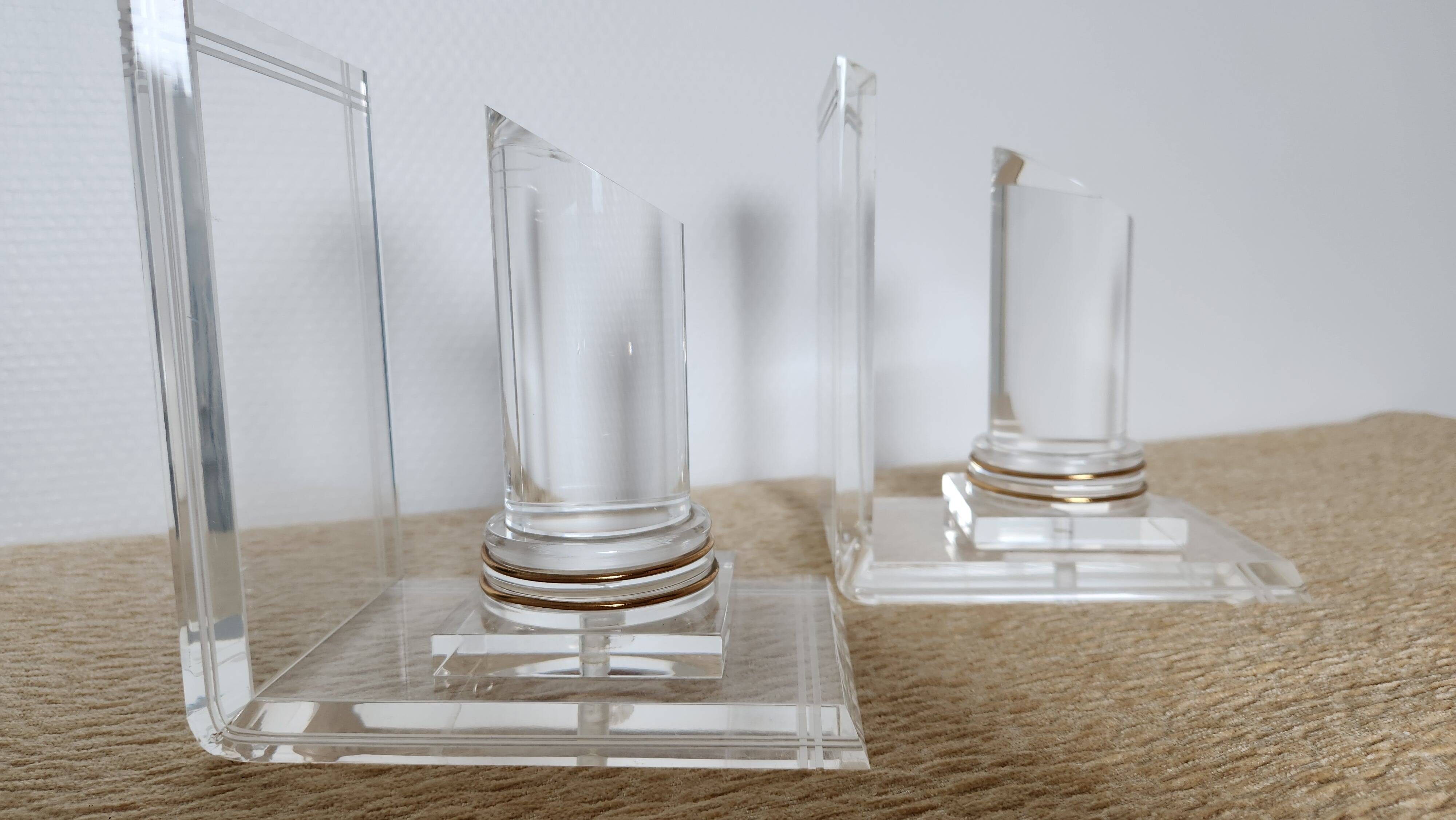 Pair of column bookends in plexiglass and gold metal, 1980s design.