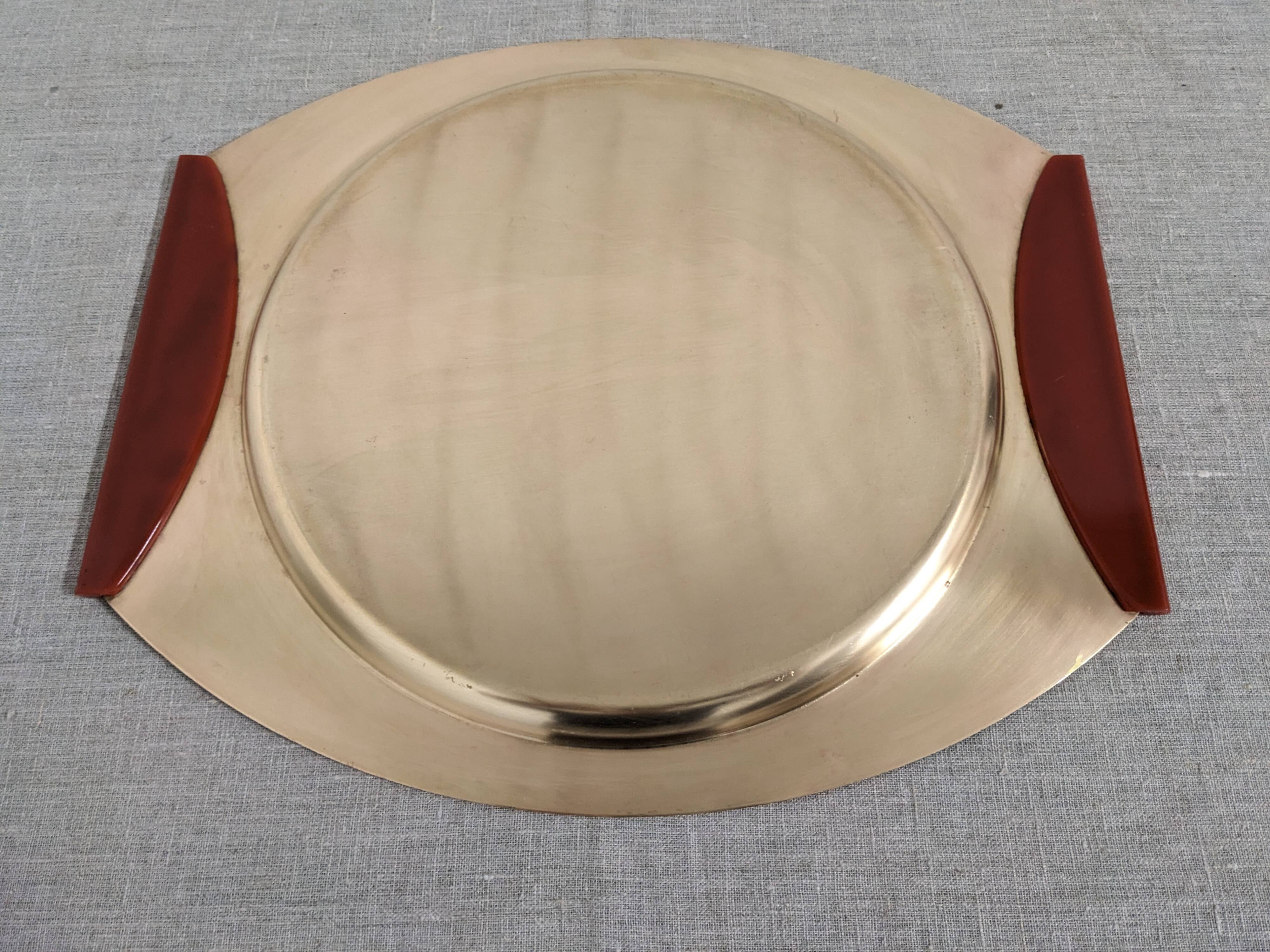 Plates and a brass and Bakelite cut by PM Italy, Italy around 1970.