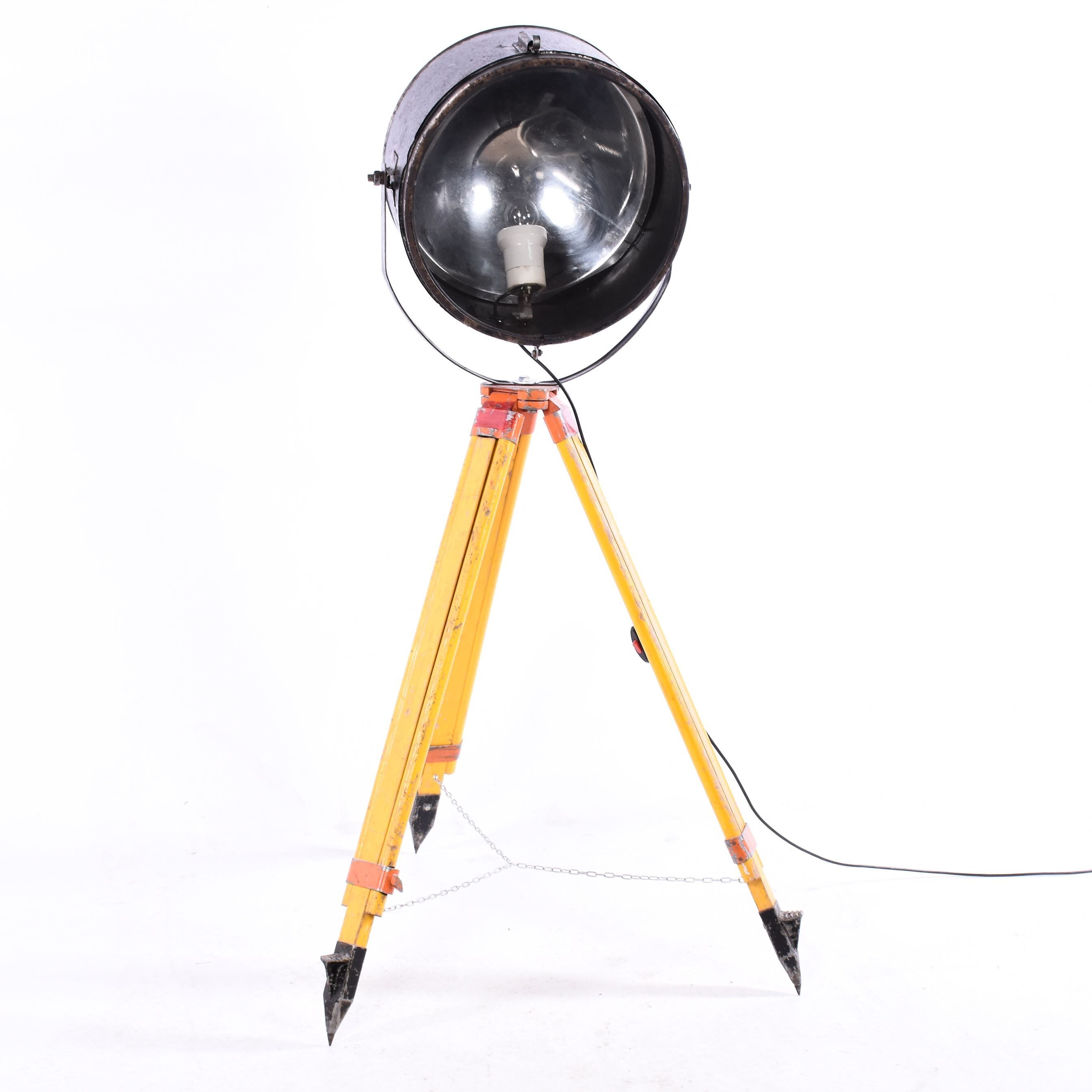 Old industrial spot on wooden tripod