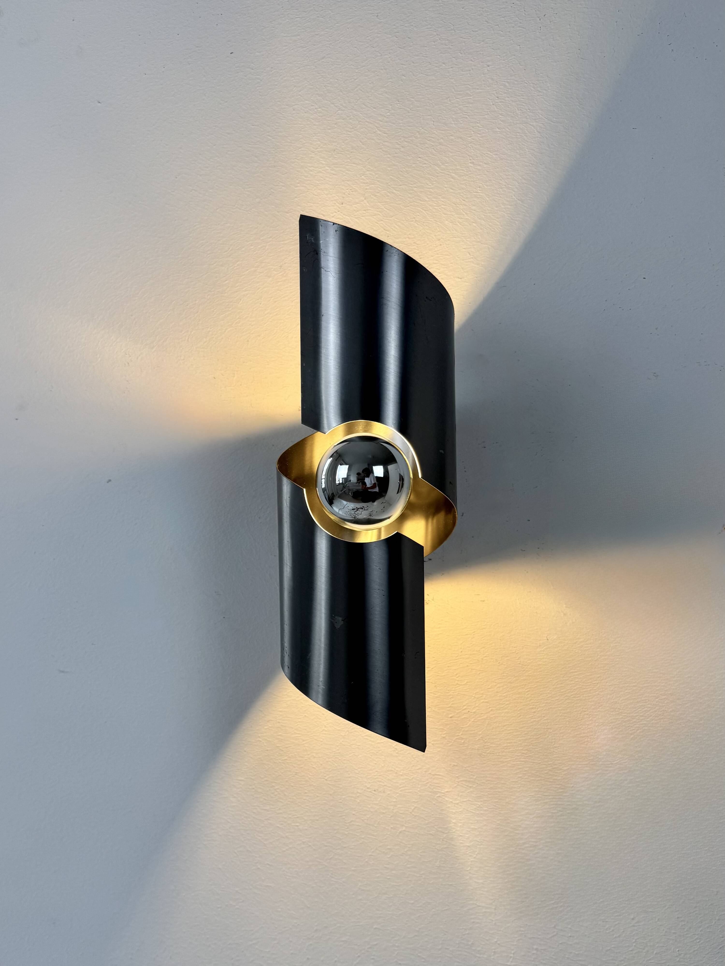 Pair of vintage wall lights, curved patinated steel, France, 1970.