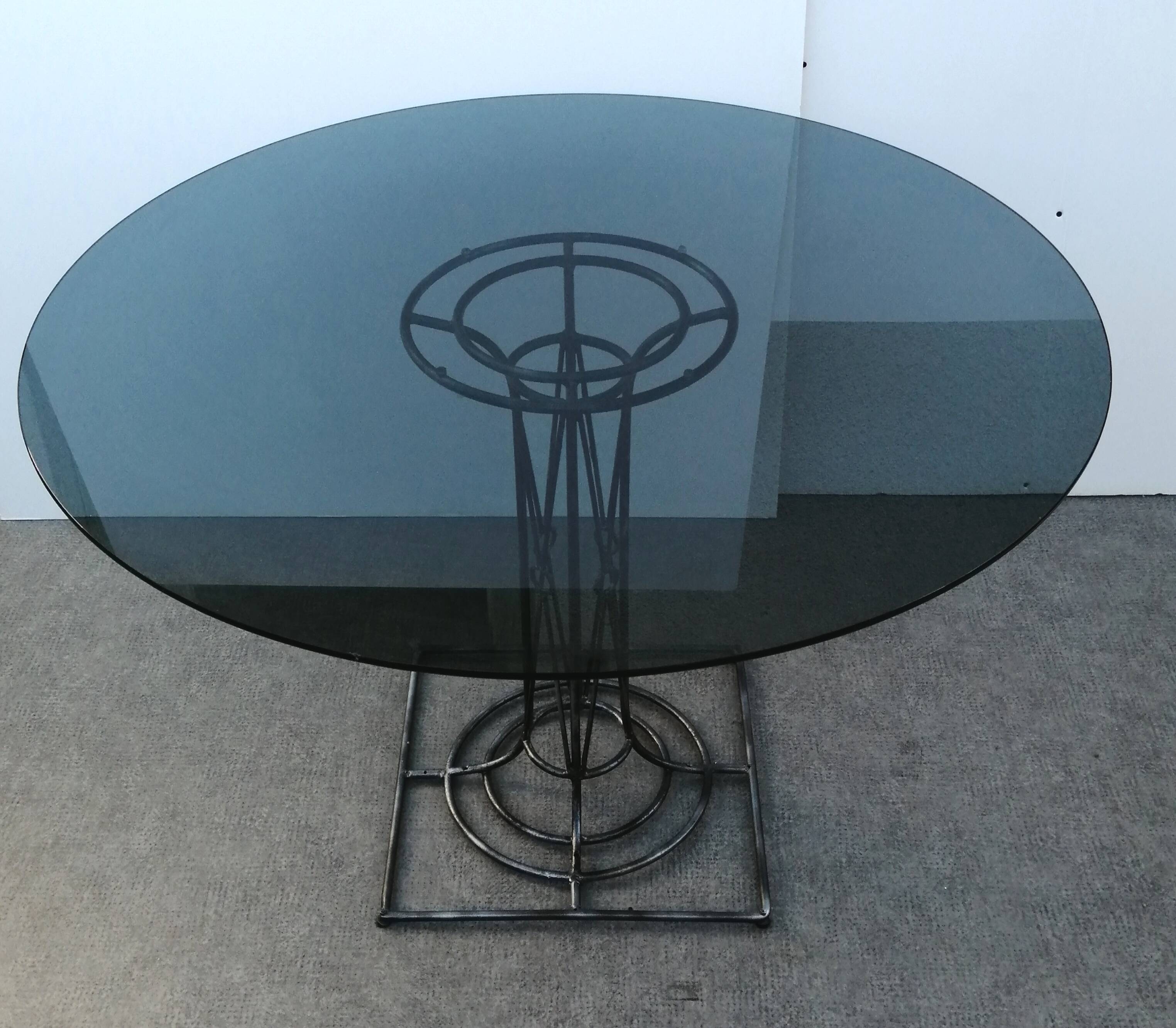Wrought iron dining table with its round smoked glass top, vintage 1980