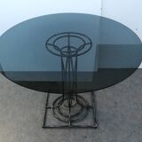 Wrought iron dining table with its round smoked glass top, vintage 1980