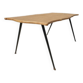 Violin-shaped coffee table with brass legs