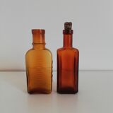 2 amber apothecary bottles