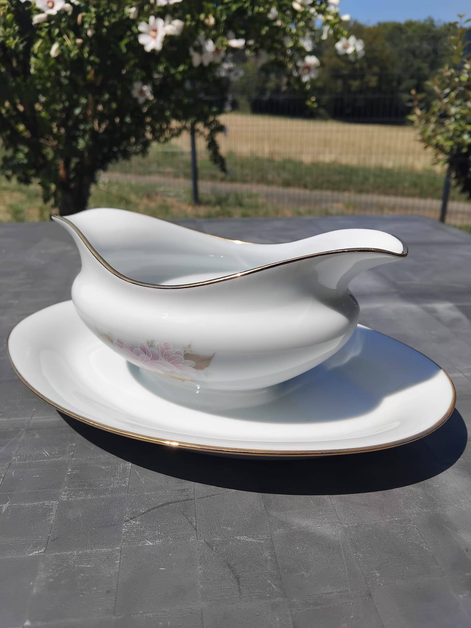 Vintage fine porcelain sauce boat with gold gilding.