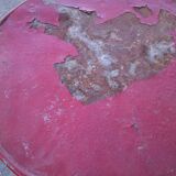 Vintage red cast iron bistro table (1950s) — round metal top, tripod base.