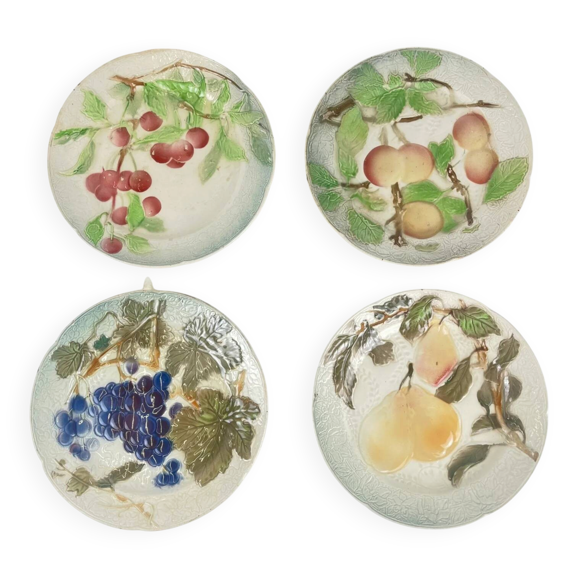 Set of 4 plates KG St Clément barbotine fruit (cherry, mirabelle, grape, pear), late 19th-early 20th century.