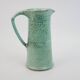 Large green ceramic pitcher with leopard enamel