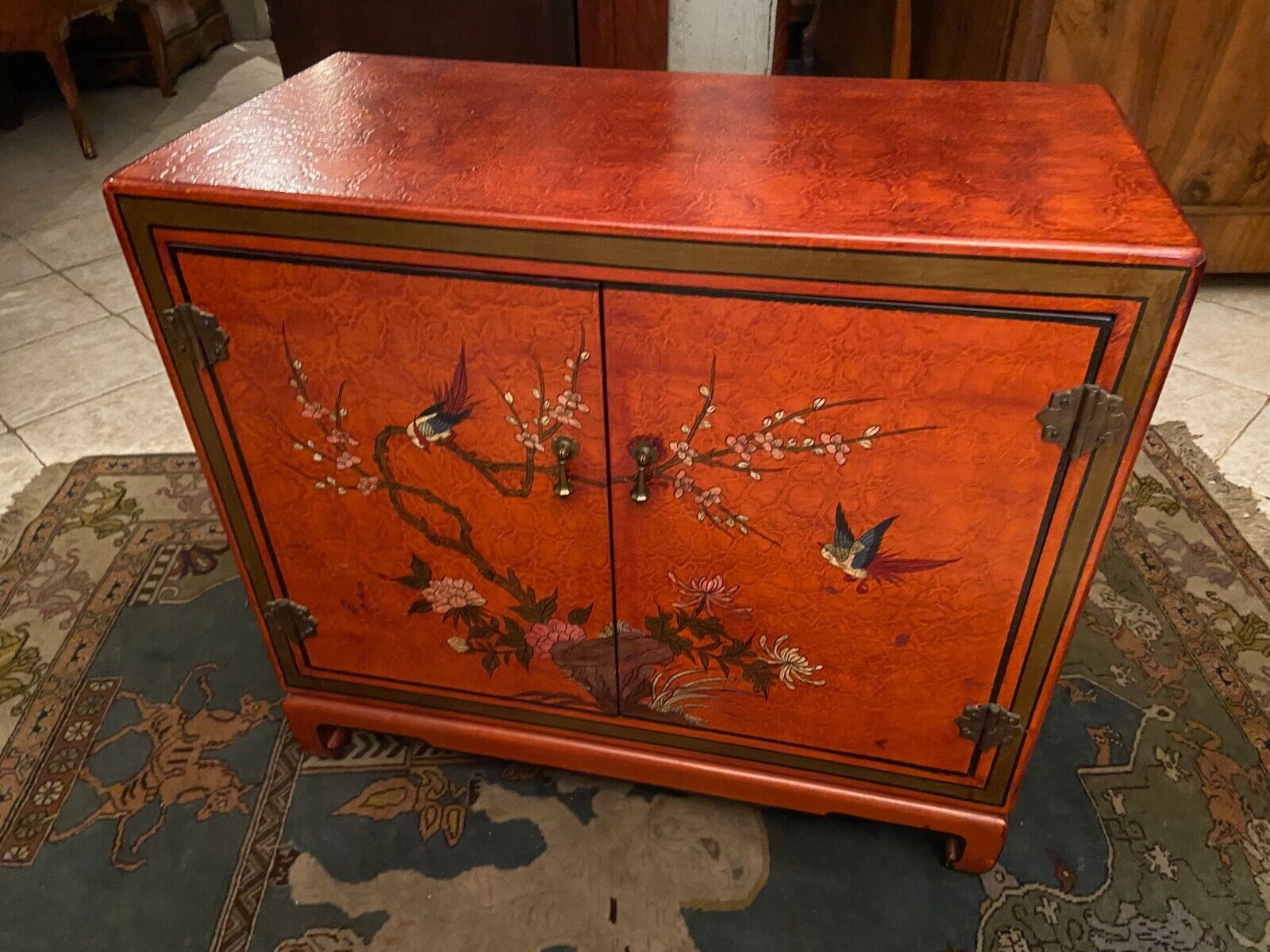 Low sideboard with lacquered decoration with birds on orange background Far East China Japan
