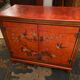 Low sideboard with lacquered decoration with birds on orange background Far East China Japan