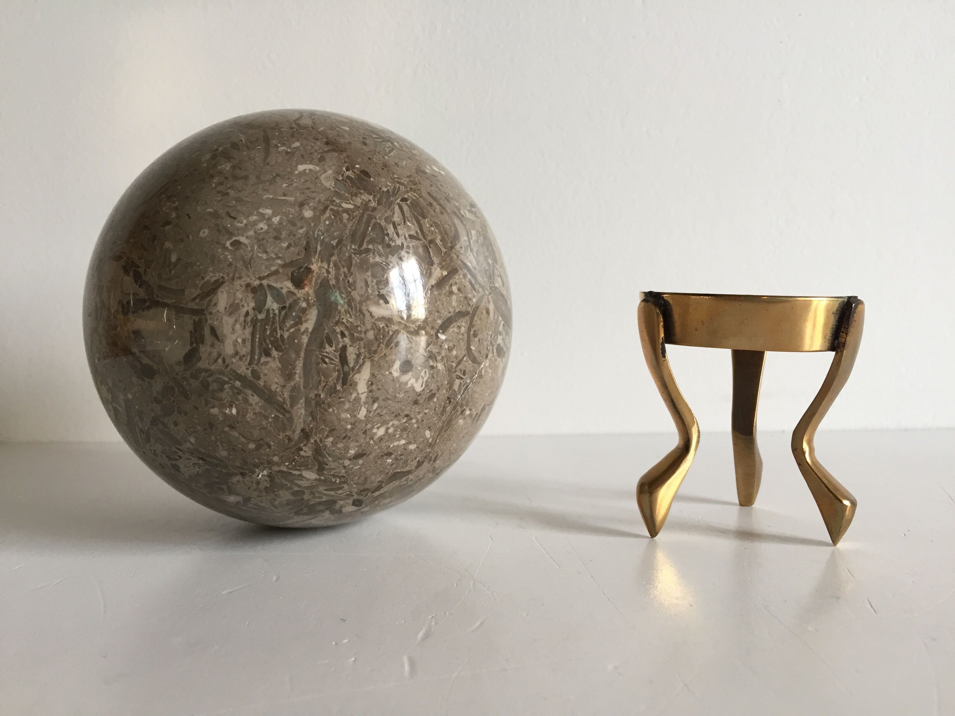 Marble ball paperweight on vintage brass