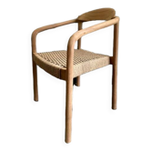 Solid wood chair with woven seat and armrests