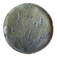 Decorative wall plaque in brass with a floral design.
