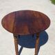 Walnut drop-leaf table with honey spoon legs.
