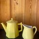 Vintage yellow ceramic teapot and milk jug.