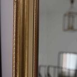 Large beveled mirror in carved wood